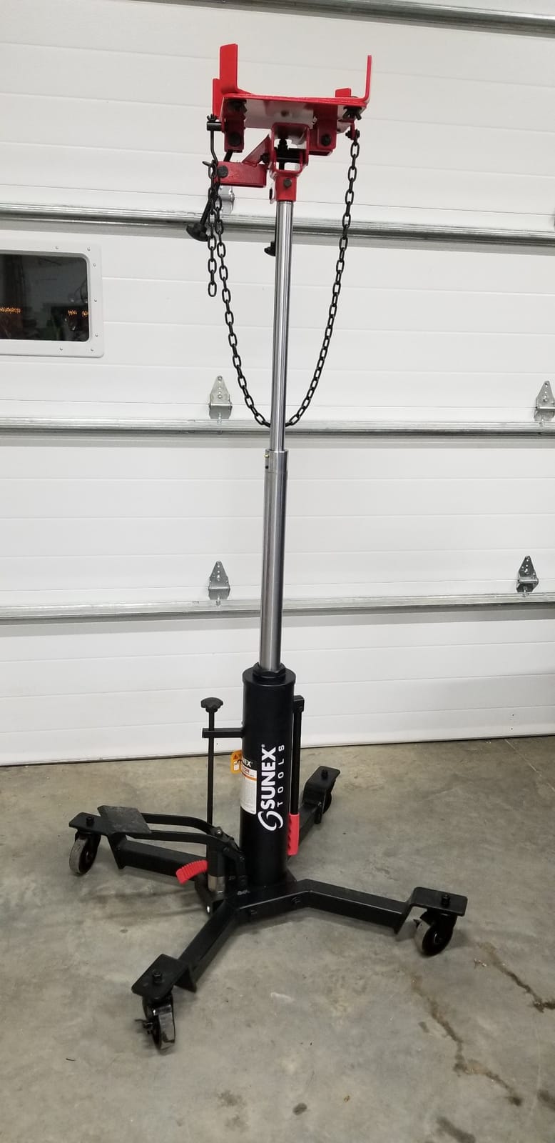 Sunex Tools 7793B 1,000 lb Telescopic Transmission Jack, Hydraulic, Foot Pump Operated, Tilt Saddle with Chain Tie-Down, 74.2 in Max Height customer photo 1